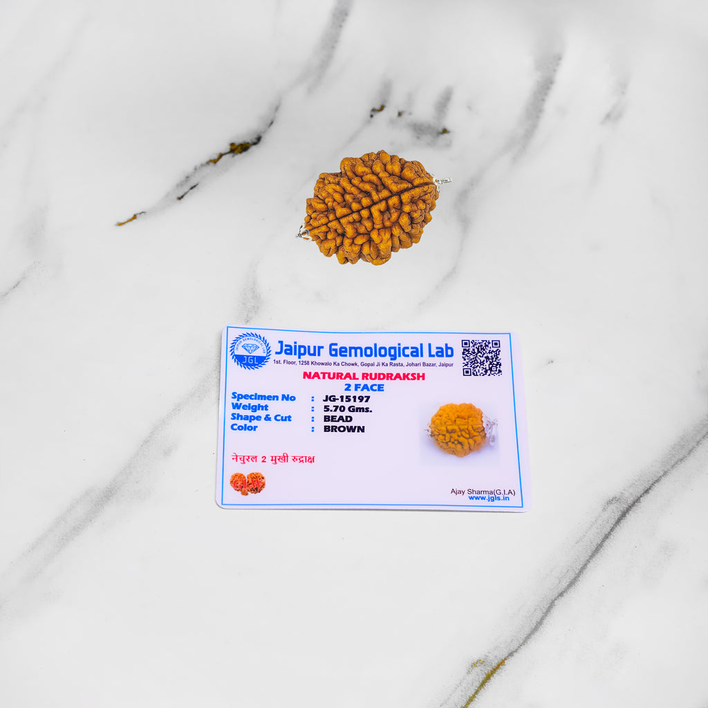 Rudraksh bead with Jaipur Gemological Lab certificate on a marble surface
