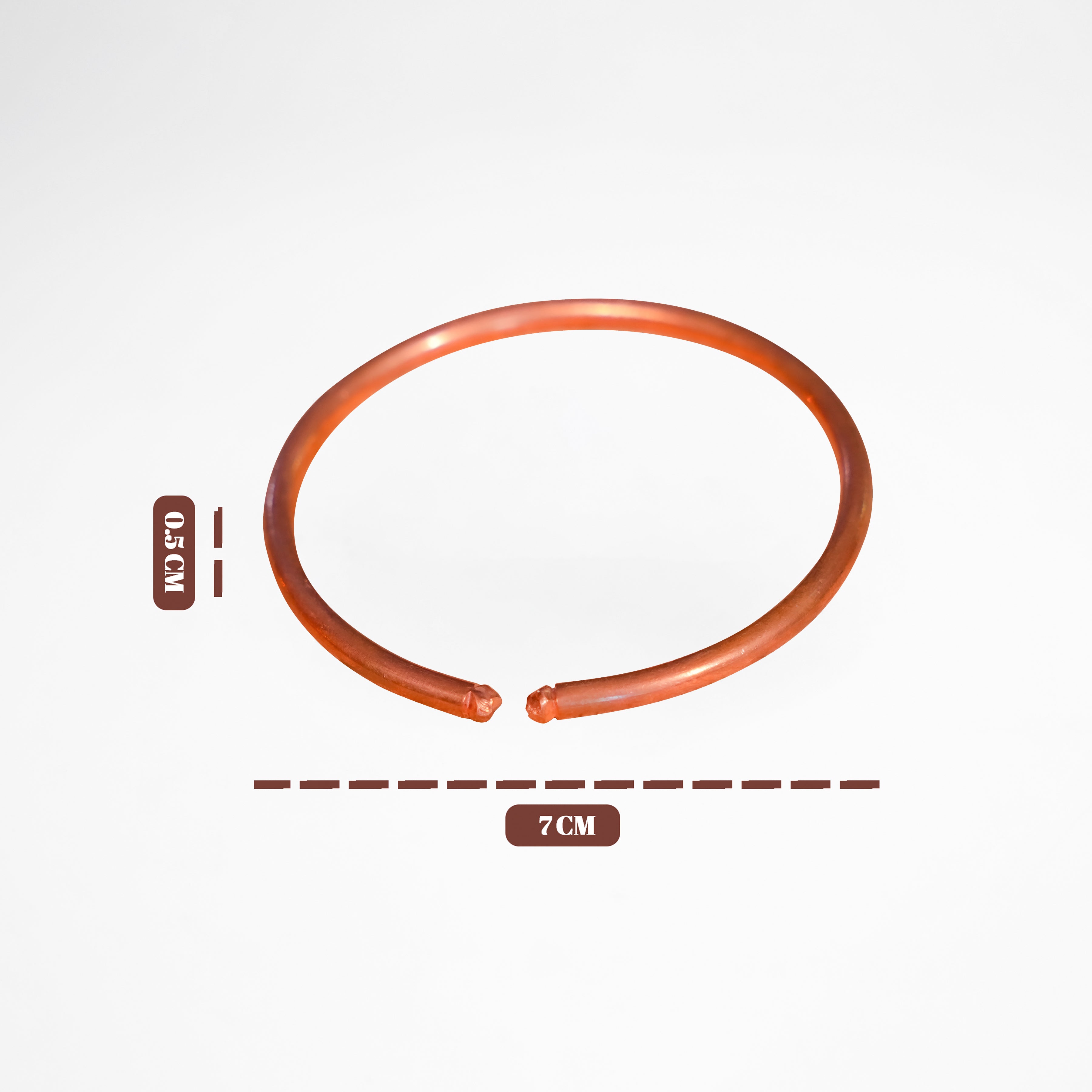 Orange rubber band with measurements on a white background