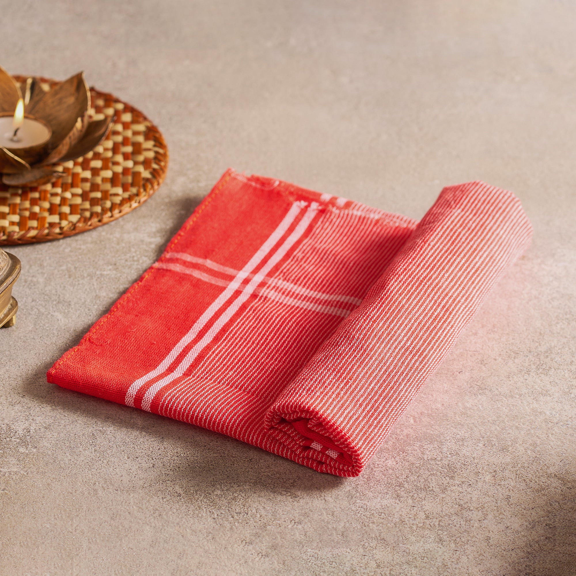 Red cloth with white stripes on a beige surface