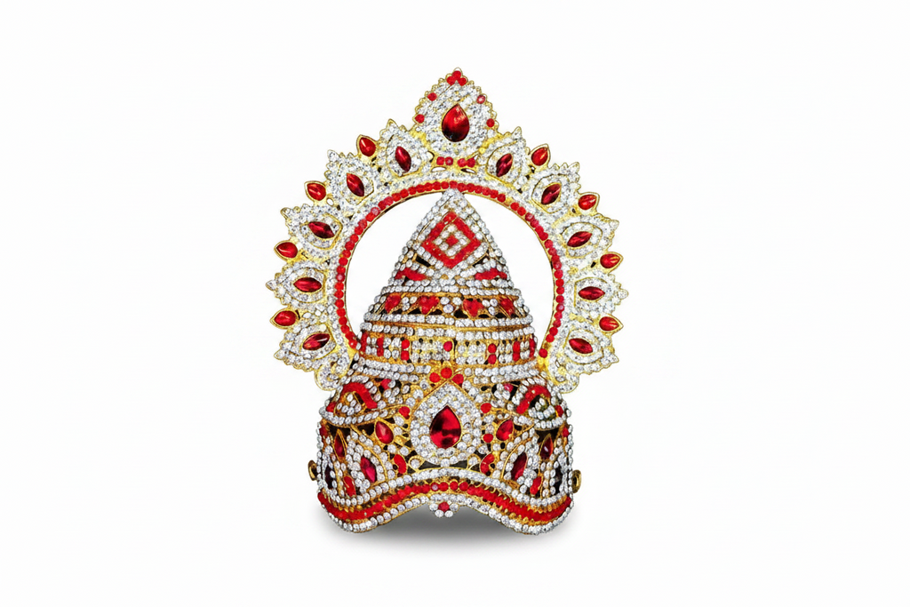 An ornate traditional Indian jewelry piece, likely a crown or decorative headdress, embellished with gold-plated metal, white stones, and red gemstones, set against a dark gray gradient background.