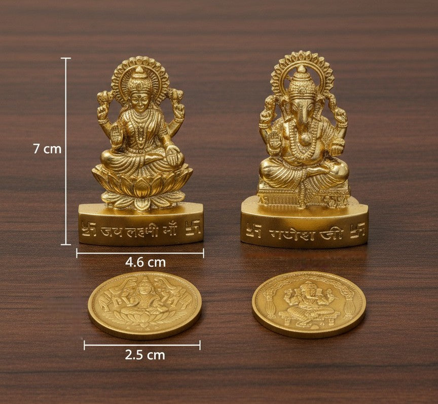 Two gold-colored statues on a wooden surface with measurements indicated.