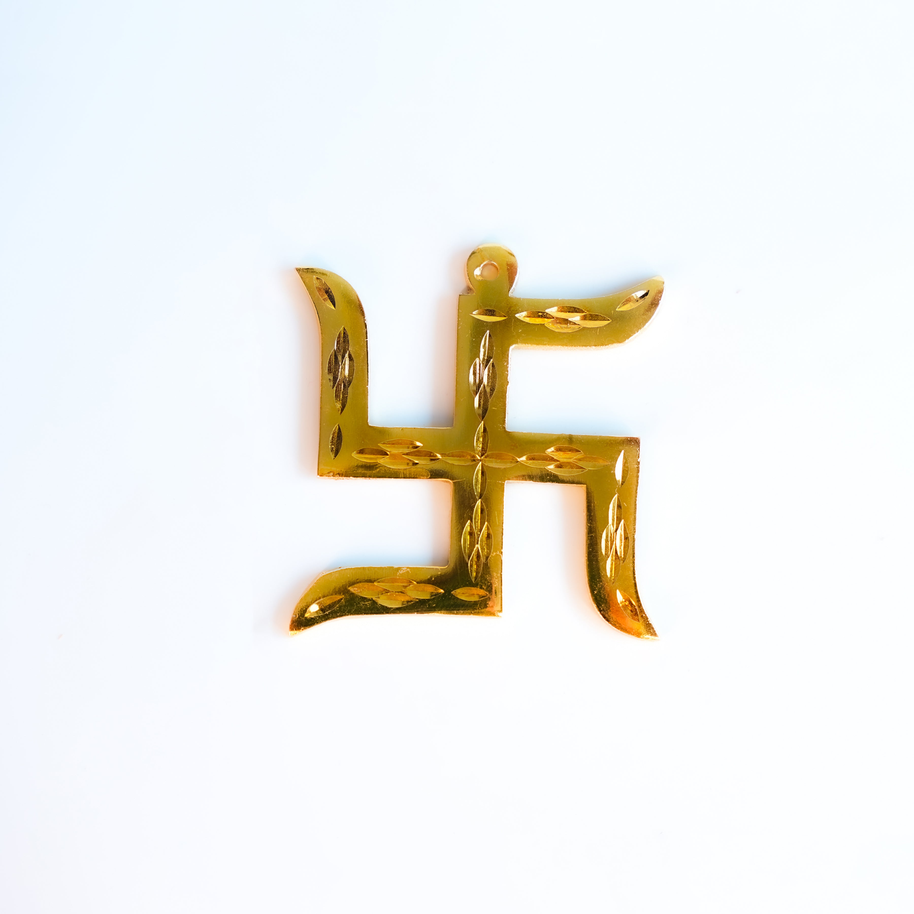 Gold swastika symbol on a white background