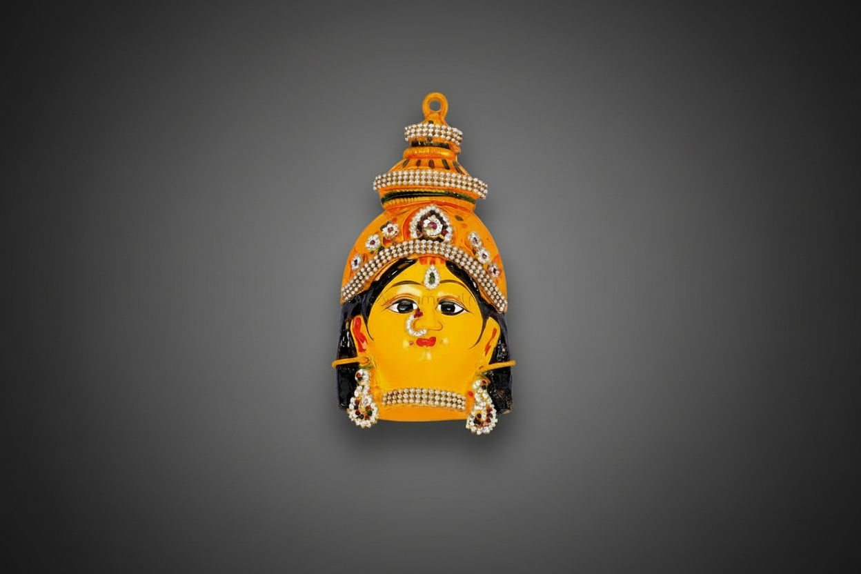 A decorative wall pin or brooch shaped like a stylized face with a crown, shown against a dark textured background.