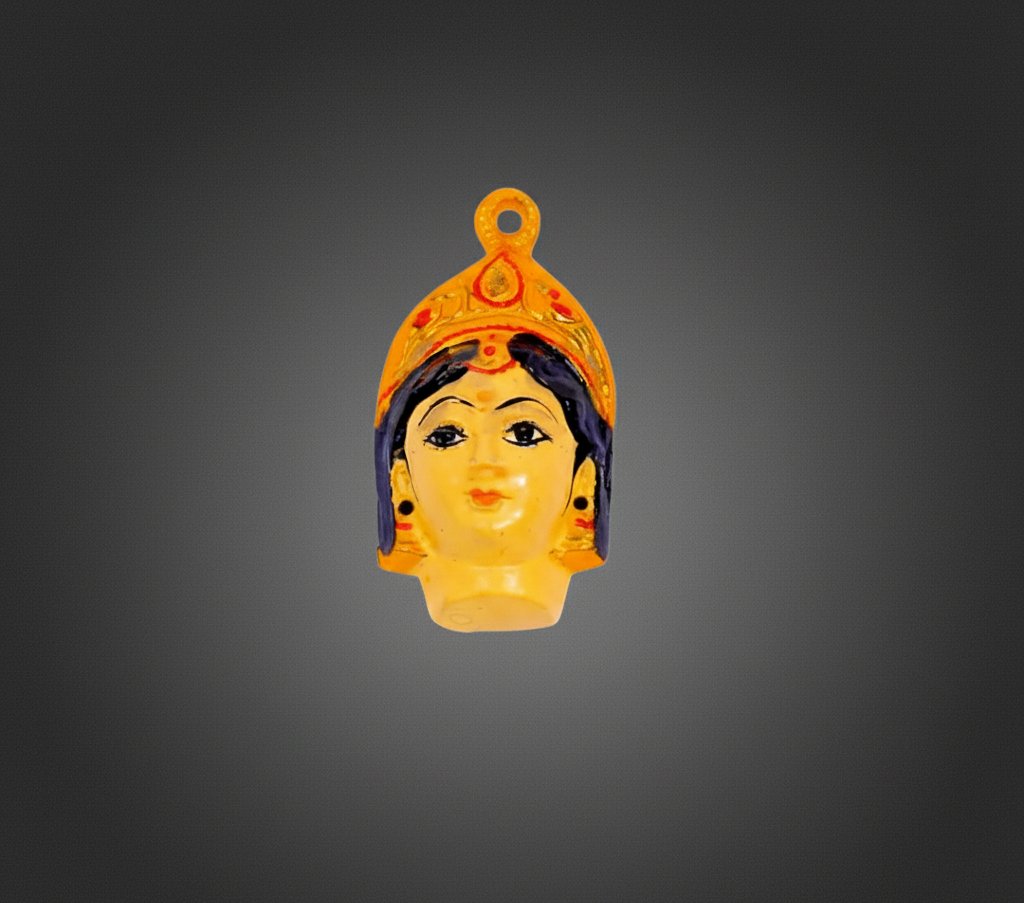 A small decorative pendant or charm shaped like a stylized face wearing an ornate yellow-orange crown, shown centered on a dark gray gradient background.