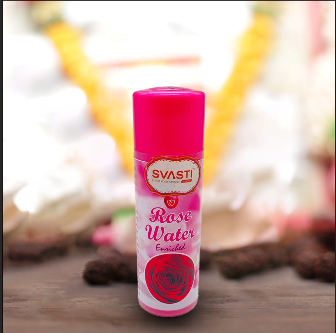 A crisp close-up showing the golden and red-bordered ornamental oval logo of the Svasti brand printed on the front of the rose water wrap.