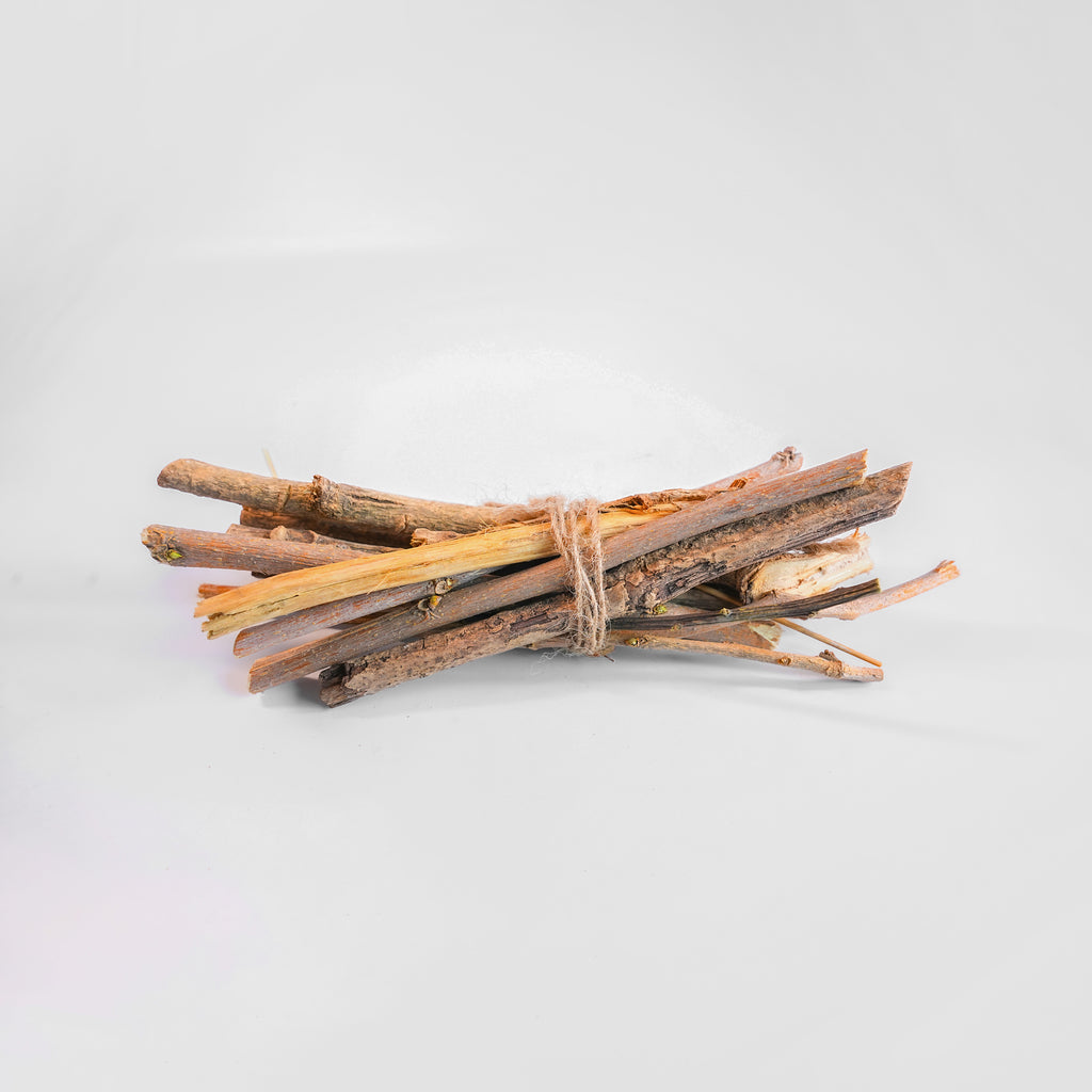 Bunch of sticks tied together on a light gray background