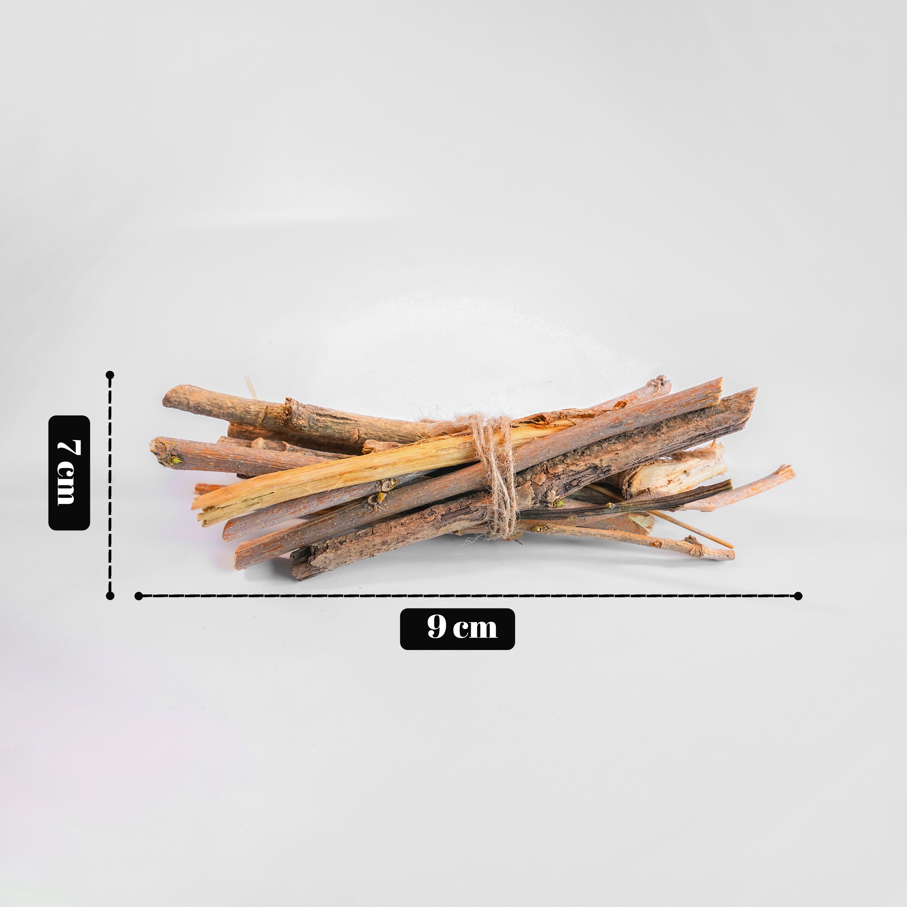 Bunch of sticks tied together with measurements on a light gray background