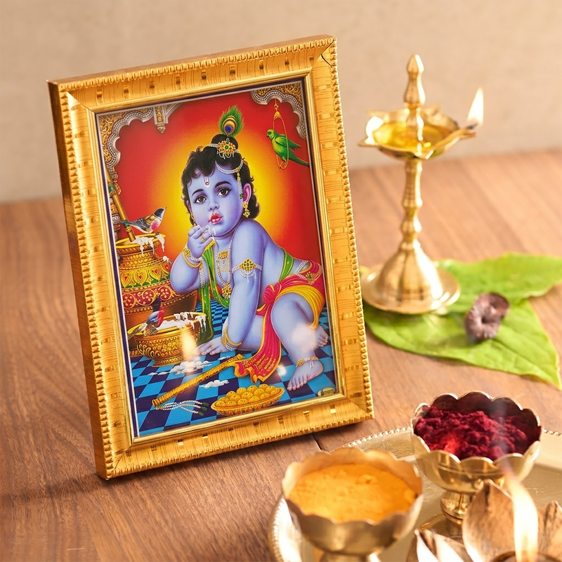 Straight-on front view of the gold-framed Bal Krishna photo, highlighting the entire colorful artwork and the structured ridge borders of the frame.