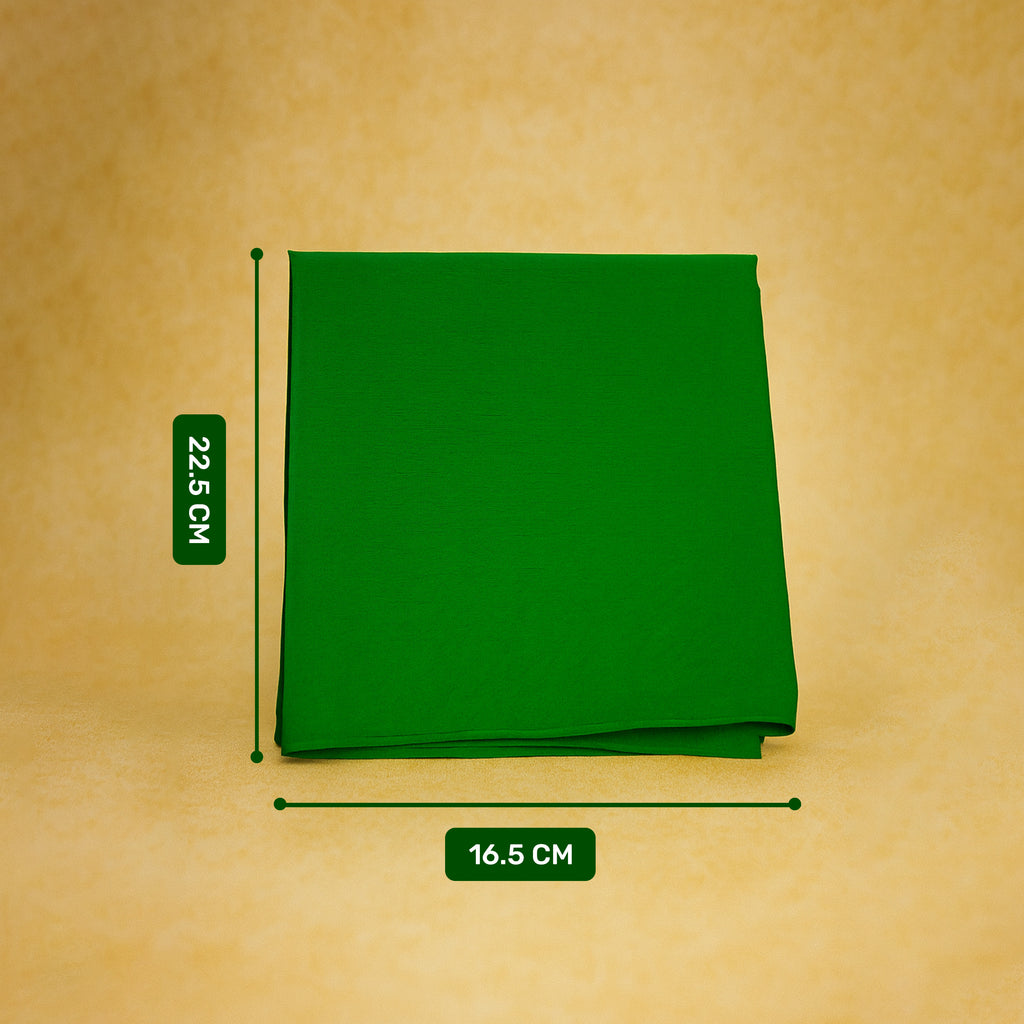 Green fabric square with measurements on a beige background