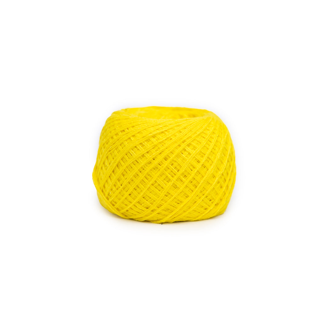 High definition top view showing the accurate geometric crosswind texture and consistent bright colour of the yellow thread ball.