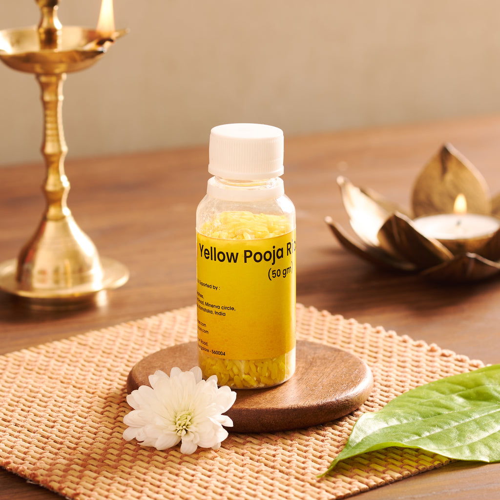 A high-definition macro shot focusing on the clean, uniform yellow coating and distinct shape of individual whole grains of ceremonial wedding Akshata.