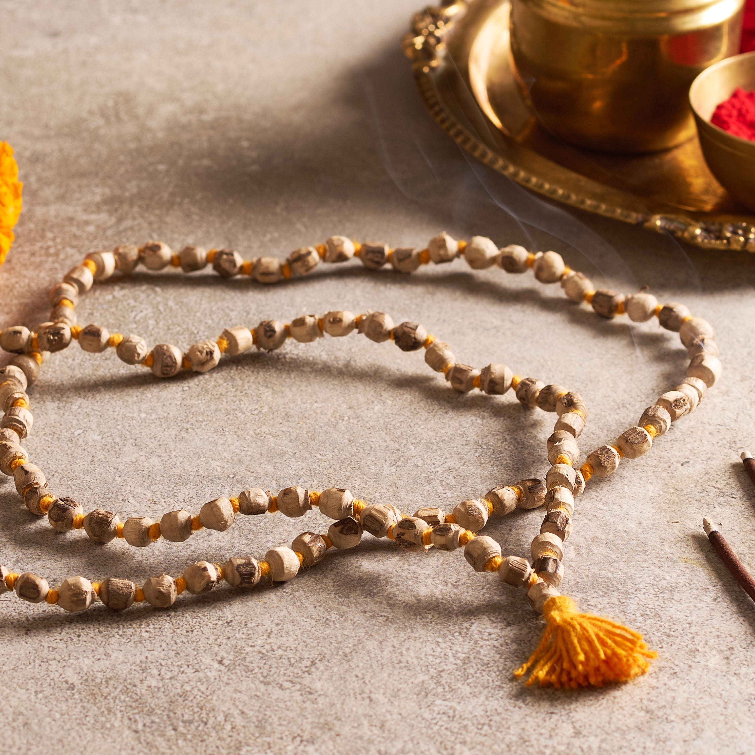Meditative necklace with tassel on a textured surface