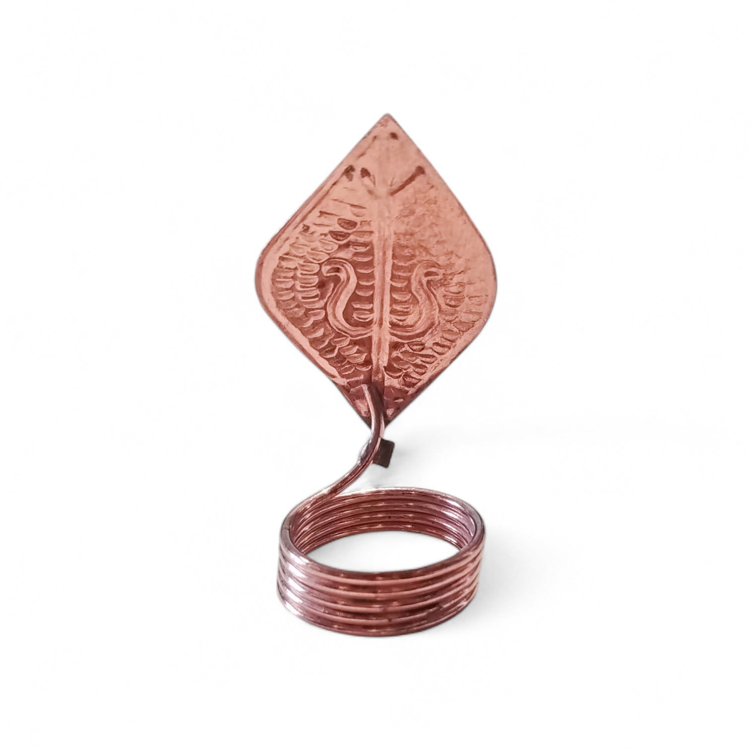 Decorative copper wall hook with embossed design on a white background