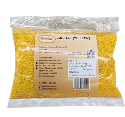 An overhead perspective of bright yellow ceremonial rice grains set up beautifully for a Hindu marriage ritual, yoga altar, or devotional pooja blessing.